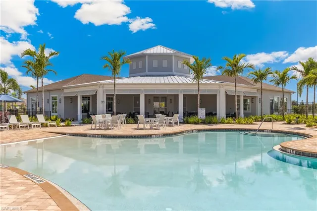 a view of a house with swimming pool patio and swimming pool
