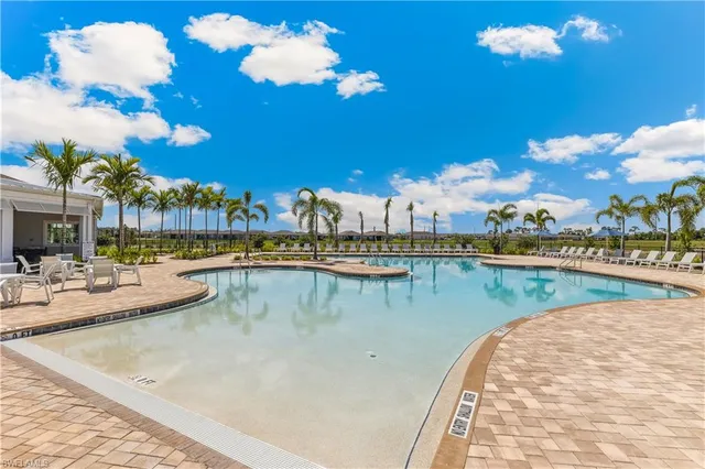 a view of a swimming pool with outdoor seating