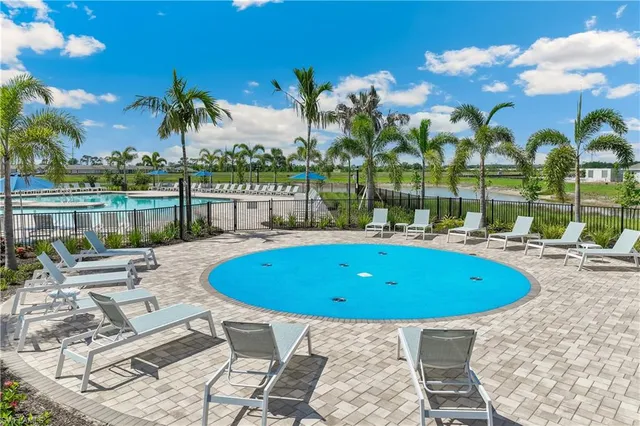 a view of swimming pool with outdoor seating and city view