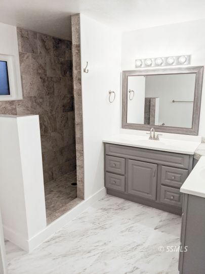 237 West Rader Avenue Ridgecrest, CA 93555 - Photo 24 of 37 a bathroom with a sink a mirror and shower