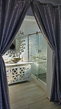 a utility room with stainless steel appliances granite countertop a sink a stove and a refrigerator