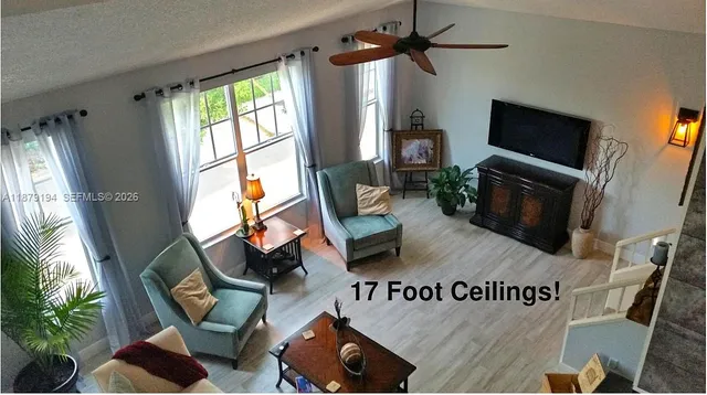 a living room with furniture and a large window