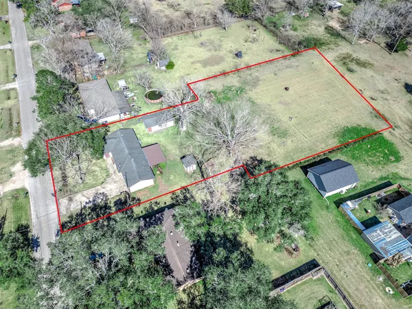 an aerial view of a tennis ground and a building