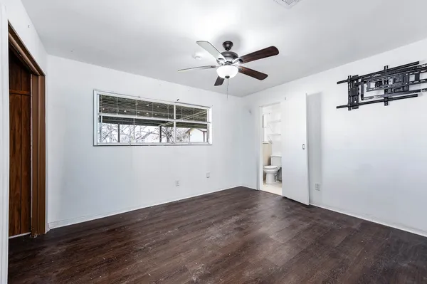a view of a big room with wooden floor and windows