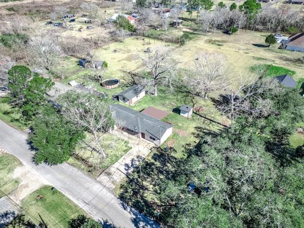 an aerial view of residential houses with trees