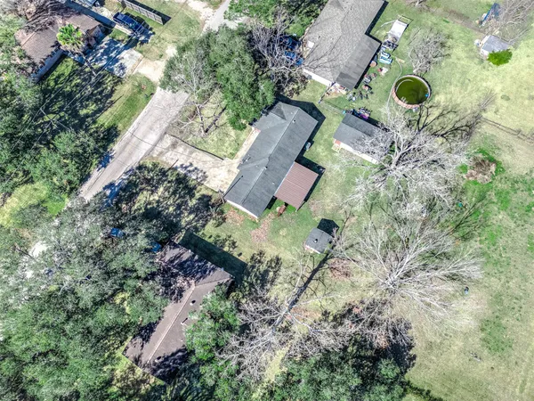 an aerial view of a house with backyard