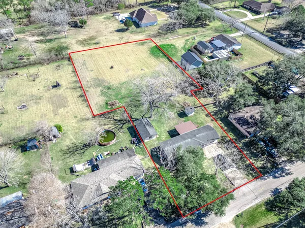 an aerial view of a house with a yard and lake view
