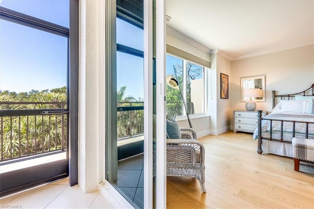 445 Cove Tower Drive, Unit 302 Naples, FL 34110 - Photo 21 of 50 Primary bedroom with sliders to balcony