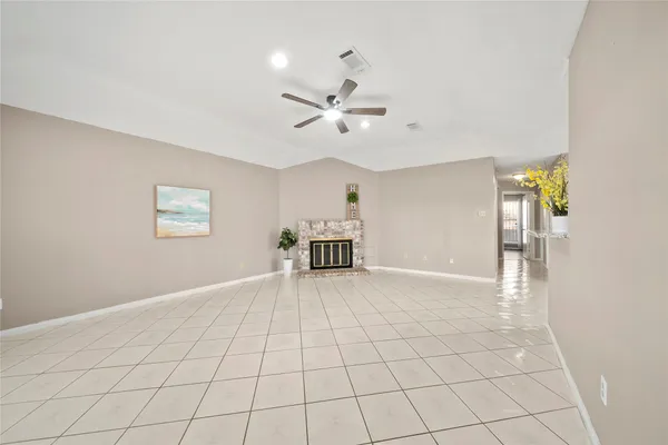 a view of an empty room and a ceiling fan