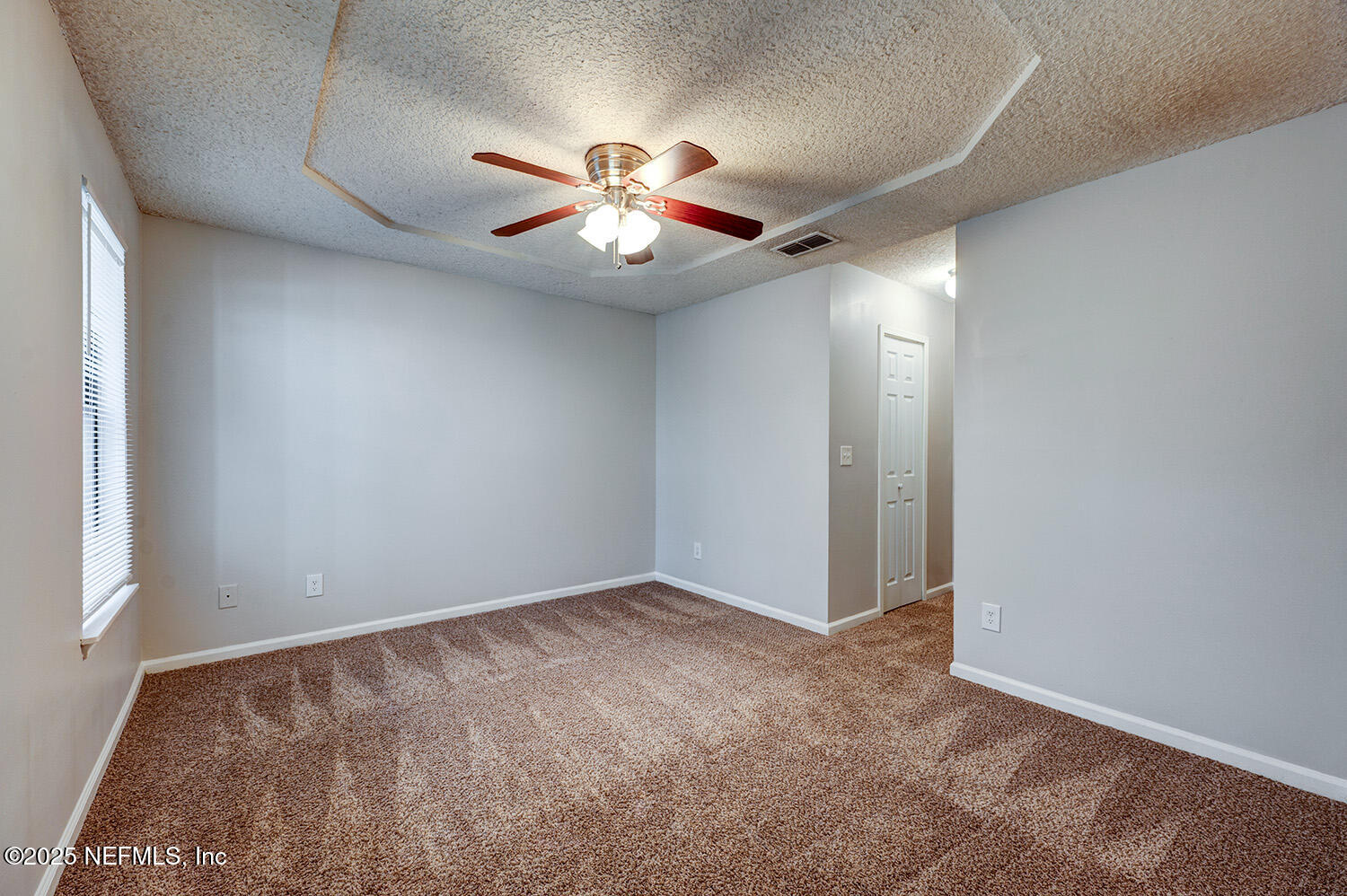 3248 Dowitcher Lane Orange Park, FL 32065 - Photo 11 of 23 an empty room with closet and a chandelier fan