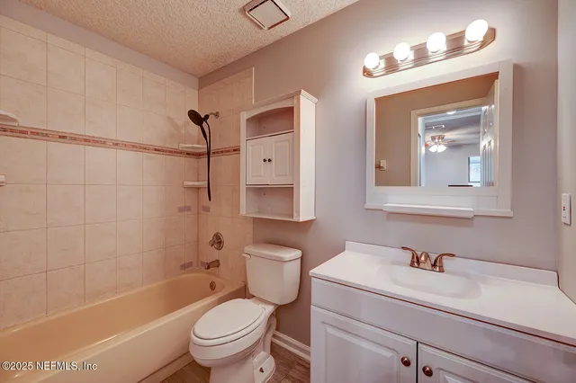 a bathroom with a toilet a sink and bathtub