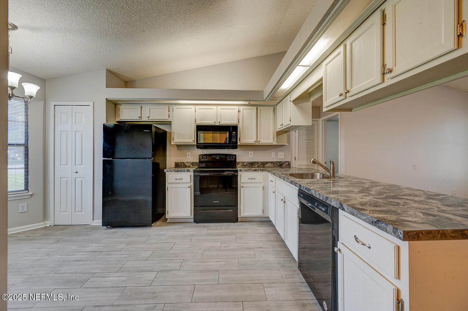 3248 Dowitcher Lane Orange Park, FL 32065 - Photo 8 of 23 a kitchen with stainless steel appliances granite countertop a refrigerator a stove and a sink