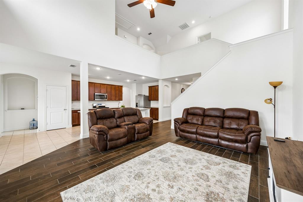 11732 Wulstone Road Fort Worth, TX 76052 - Photo 5 of 34 Expansive living area with high ceilings, recessed lighting, and wood-finish flooring