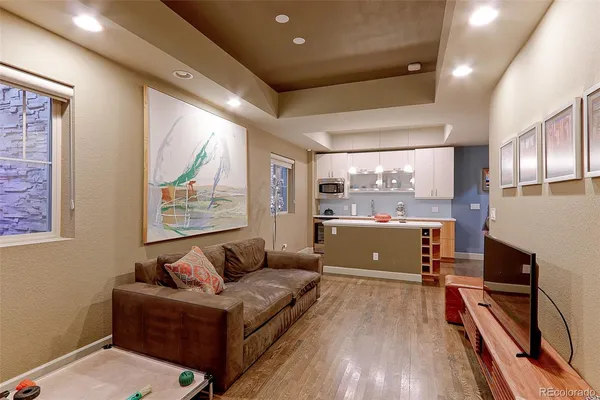 a living room with furniture and a wooden floor