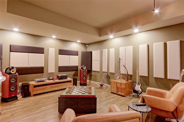 a living room with furniture a ceiling fan and a wooden floor