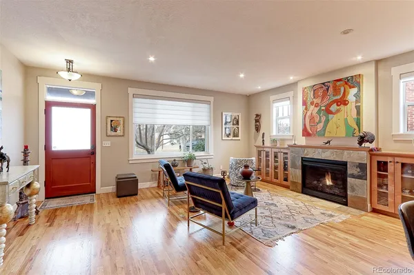 a living room with furniture and a fireplace