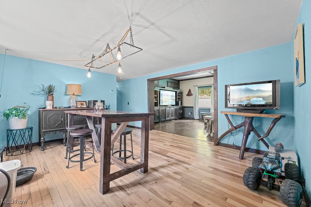 3271 Gorge Road Southwest Dellroy, OH 44620 - Photo 11 of 48 Dining room featuring hardwood / wood-style floors and a notable chandelier