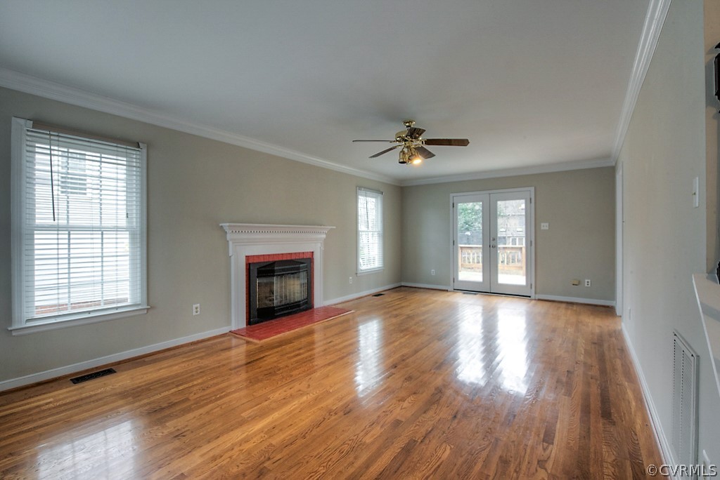 13910 Sandy Oak Road Chester, VA 23831 - Photo 8 of 32 a view of an empty room with wooden floor fireplace and a window