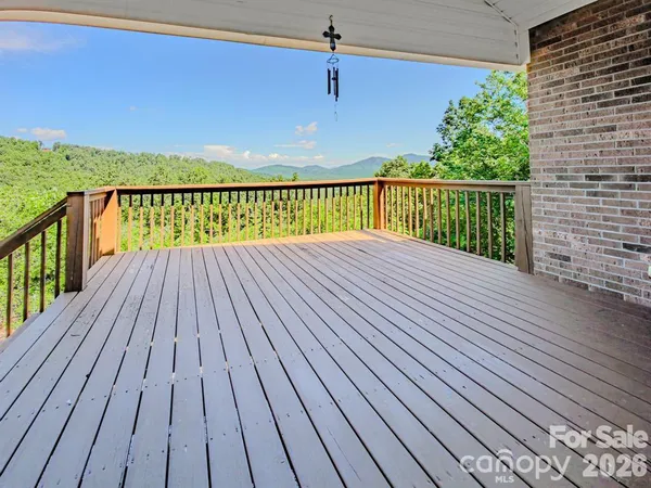 a view of balcony with wooden floor