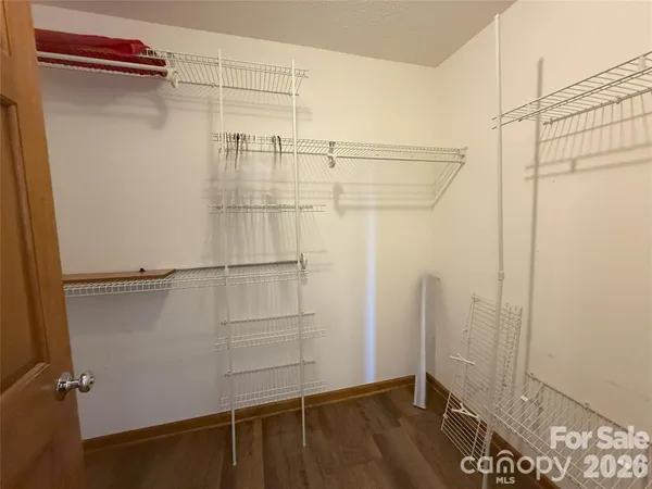 a view of hallway with wooden floor