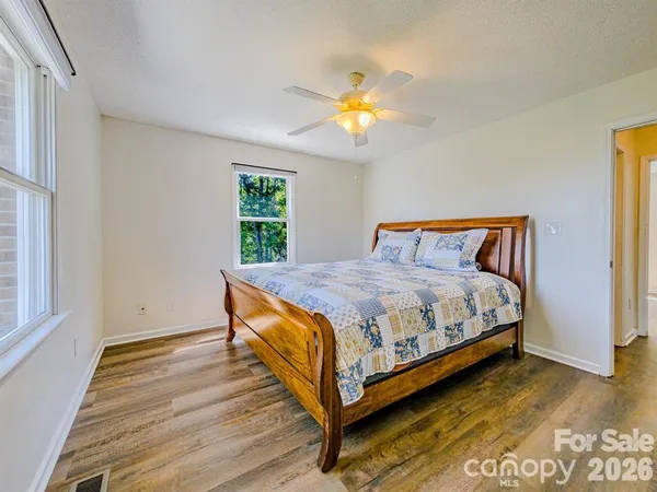 a bed sitting in a bedroom next to a window