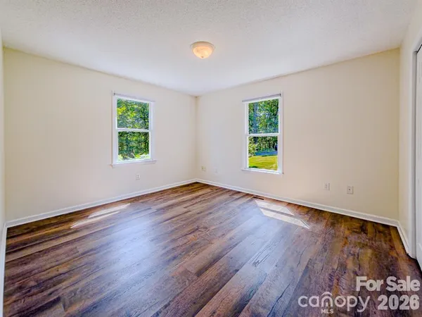 a view of room with window and hardwood floor