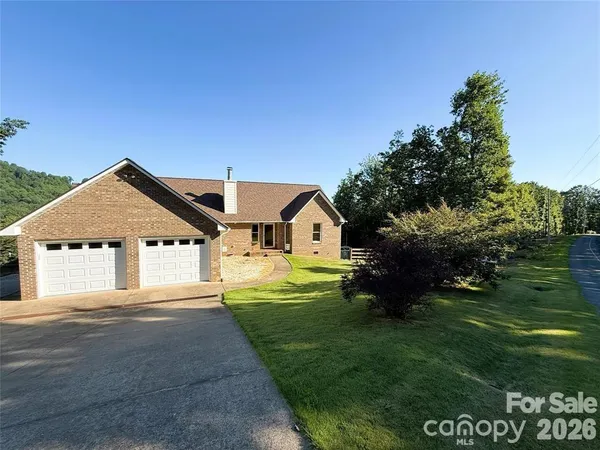 a aerial view of a house next to a yard