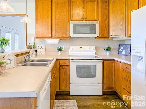 a kitchen with stainless steel appliances a stove a sink a microwave and cabinets