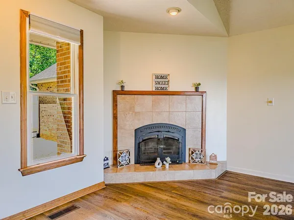 a view of a livingroom with a fireplace and window