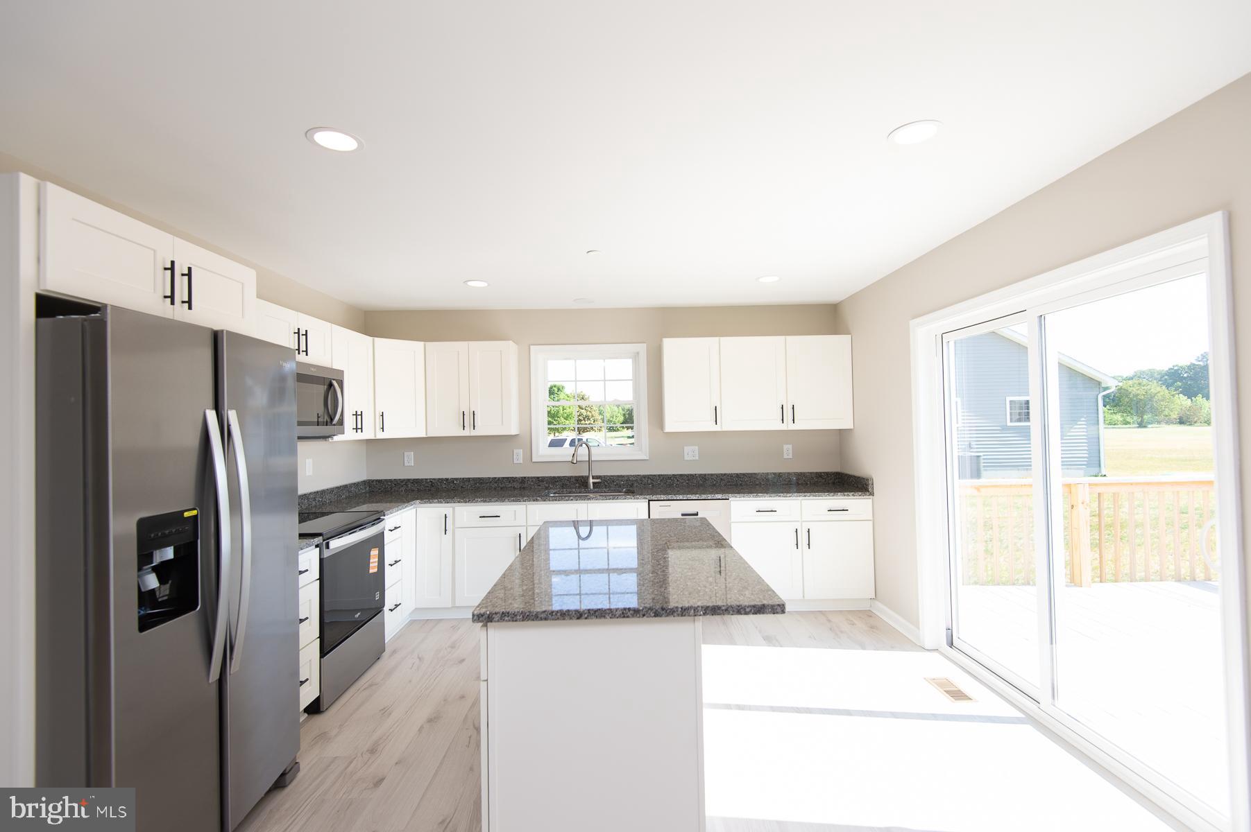Wrights Rest Road Hurlock, MD 21643 - Photo 13 of 22 a kitchen with stainless steel appliances granite countertop a refrigerator a stove and a sink with large window