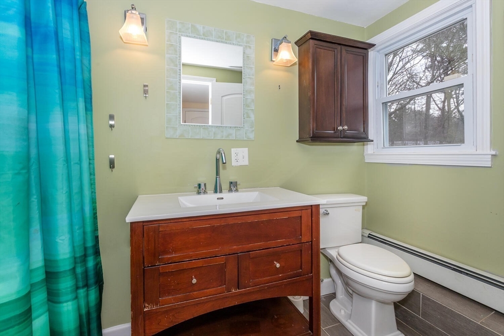 300 Chapman Street Canton, MA 02021 - Photo 12 of 16 a bathroom with a toilet a sink and mirror