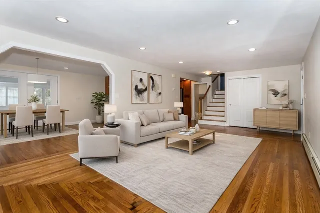 a living room with furniture and wooden floor