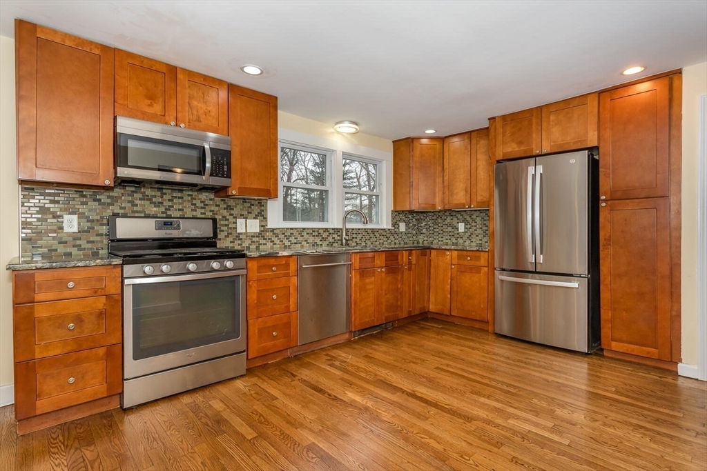 300 Chapman Street Canton, MA 02021 - Photo 5 of 16 a kitchen with stainless steel appliances granite countertop a refrigerator stove top oven and sink