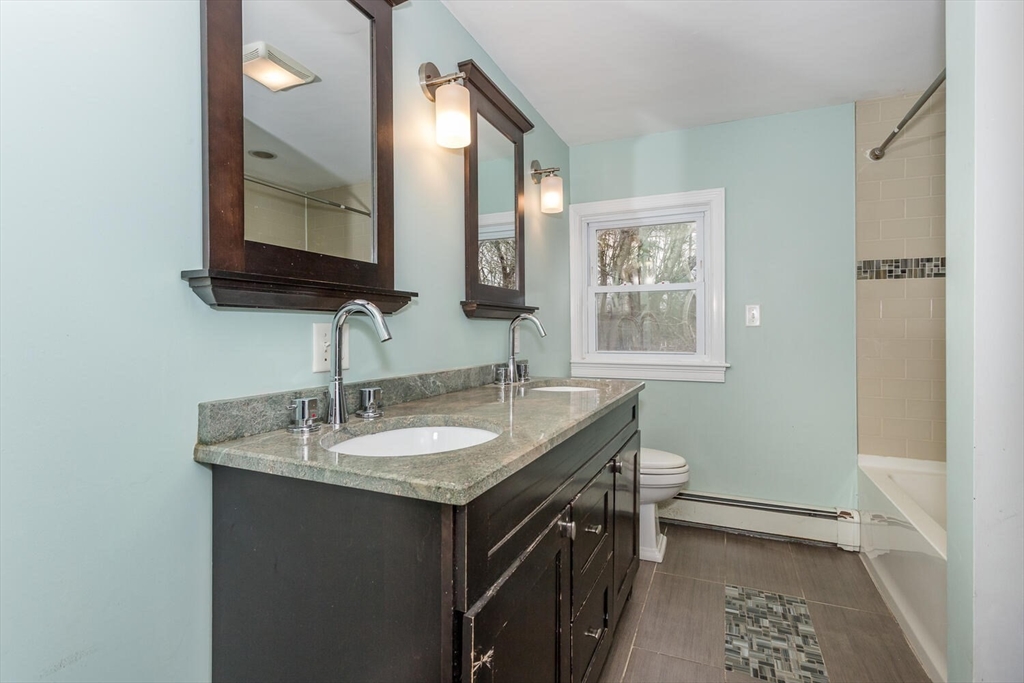 300 Chapman Street Canton, MA 02021 - Photo 9 of 16 a bathroom with a granite countertop sink and a mirror