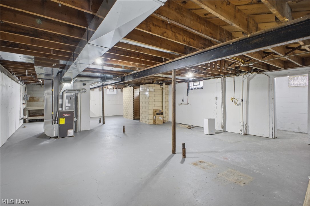 3232 Bears Den Road Youngstown, OH 44511 - Photo 23 of 38 Expansive basement space featuring exposed wood joists and a painted concrete floor