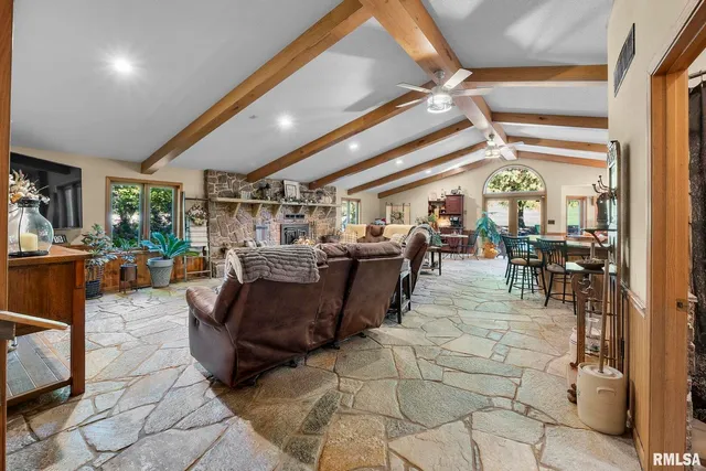 a living room with lots of furniture and a large window