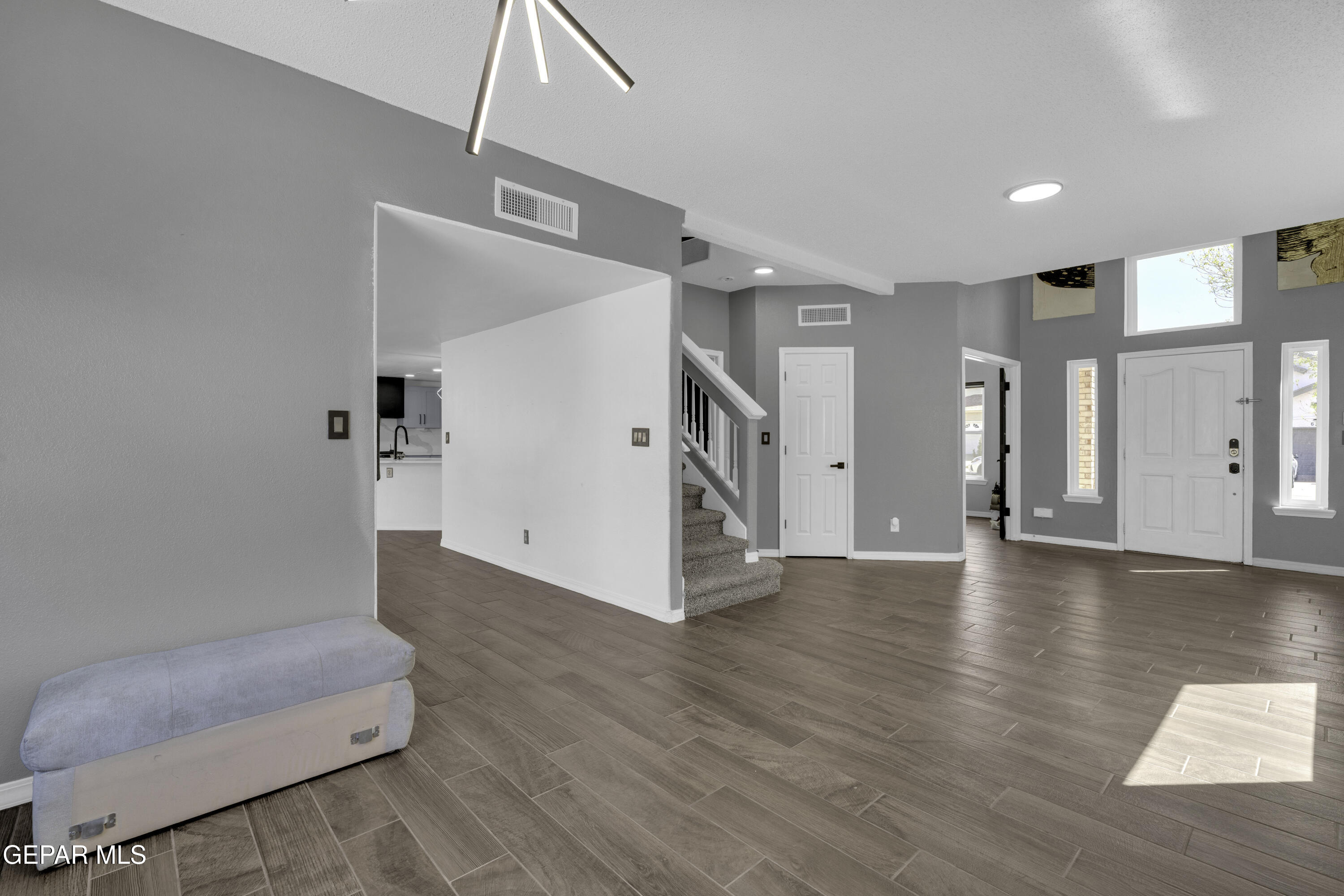 6341 Cougar Ridge Lane El Paso, TX 79912 - Photo 22 of 71 a view of a livingroom with wooden floor and a hallway
