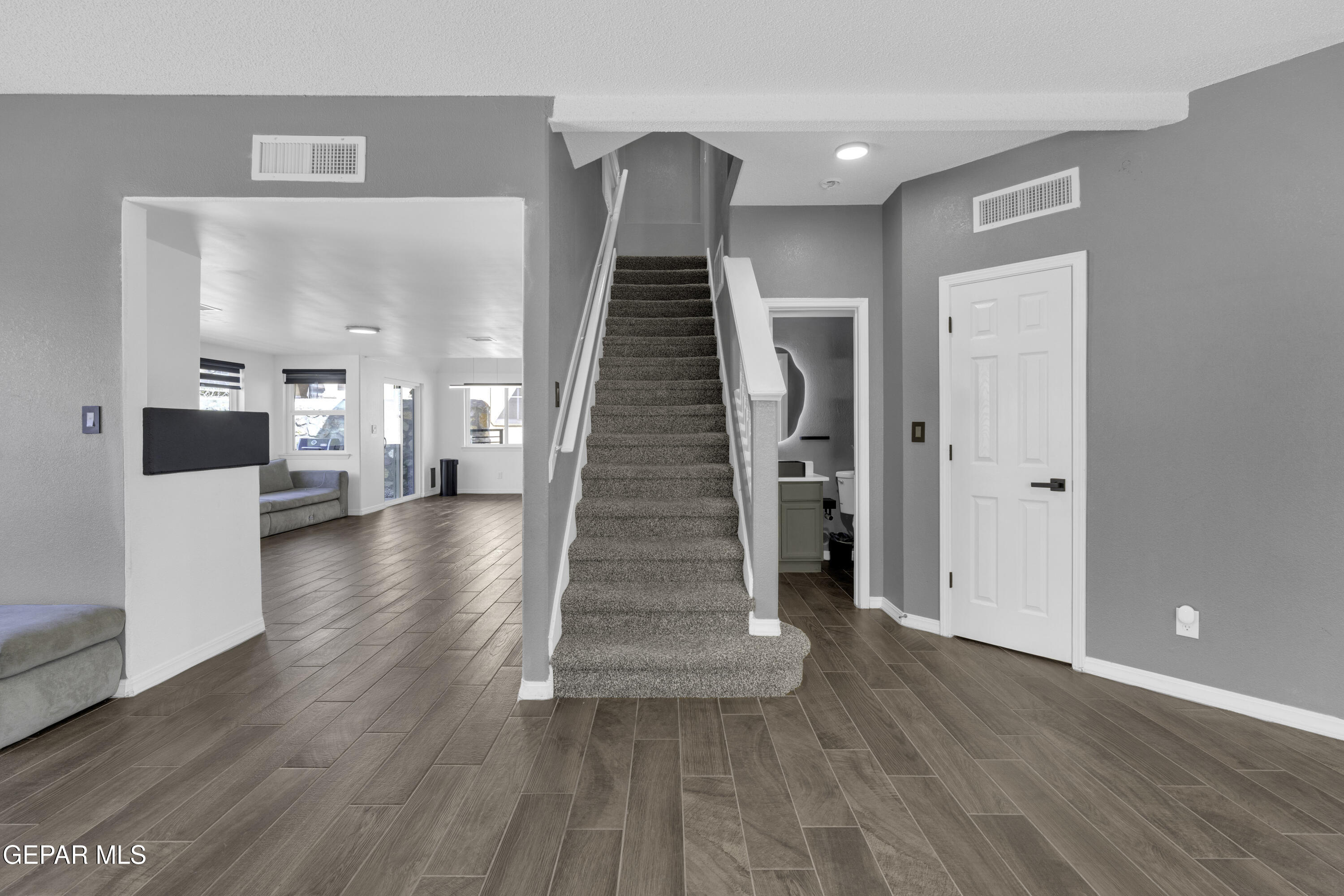 6341 Cougar Ridge Lane El Paso, TX 79912 - Photo 23 of 71 a view of a hallway view with wooden floor and staircase