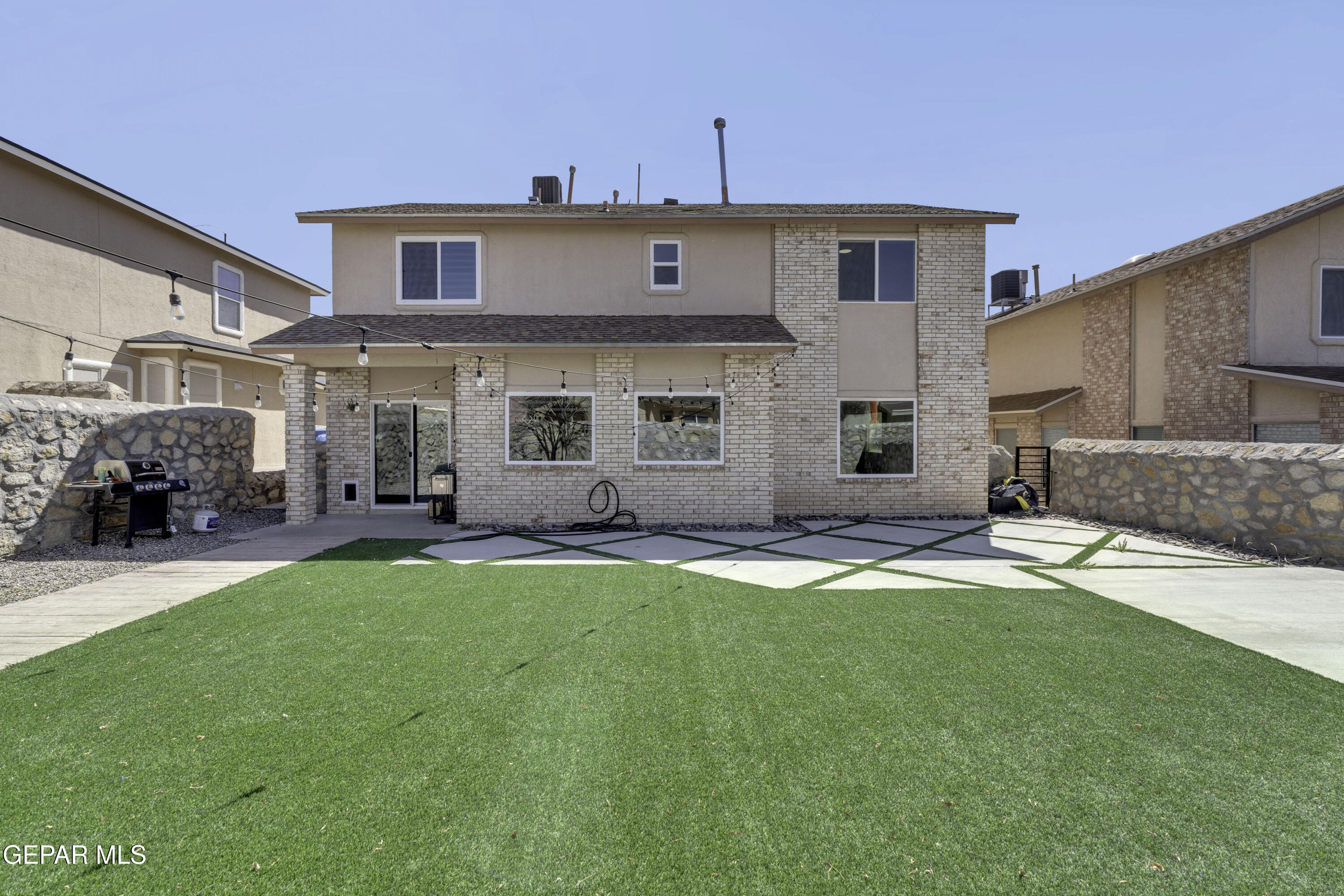 6341 Cougar Ridge Lane El Paso, TX 79912 - Photo 59 of 71 a front view of a house with a garden and yard