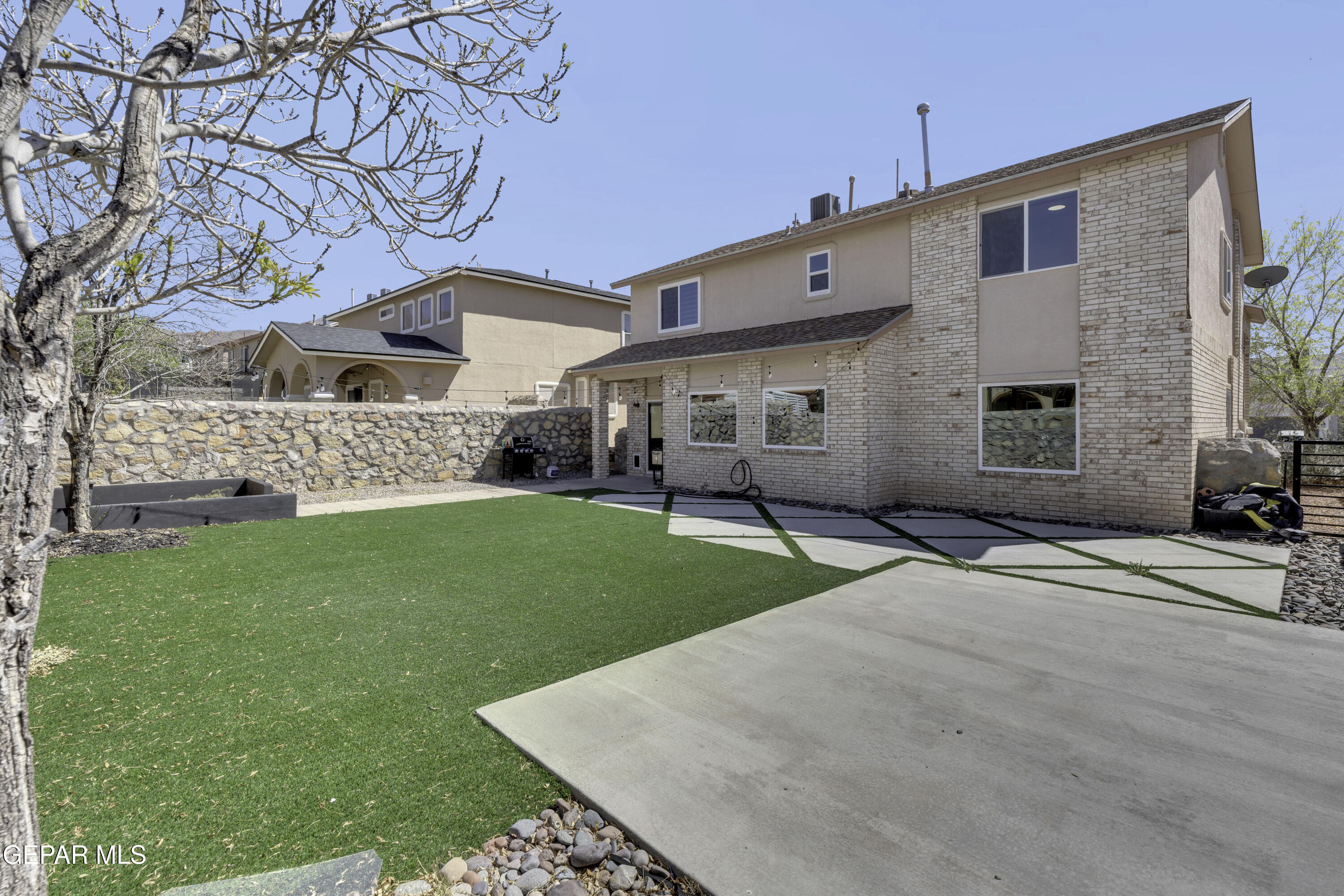 6341 Cougar Ridge Lane El Paso, TX 79912 - Photo 60 of 71 a front view of a house with a garden and yard