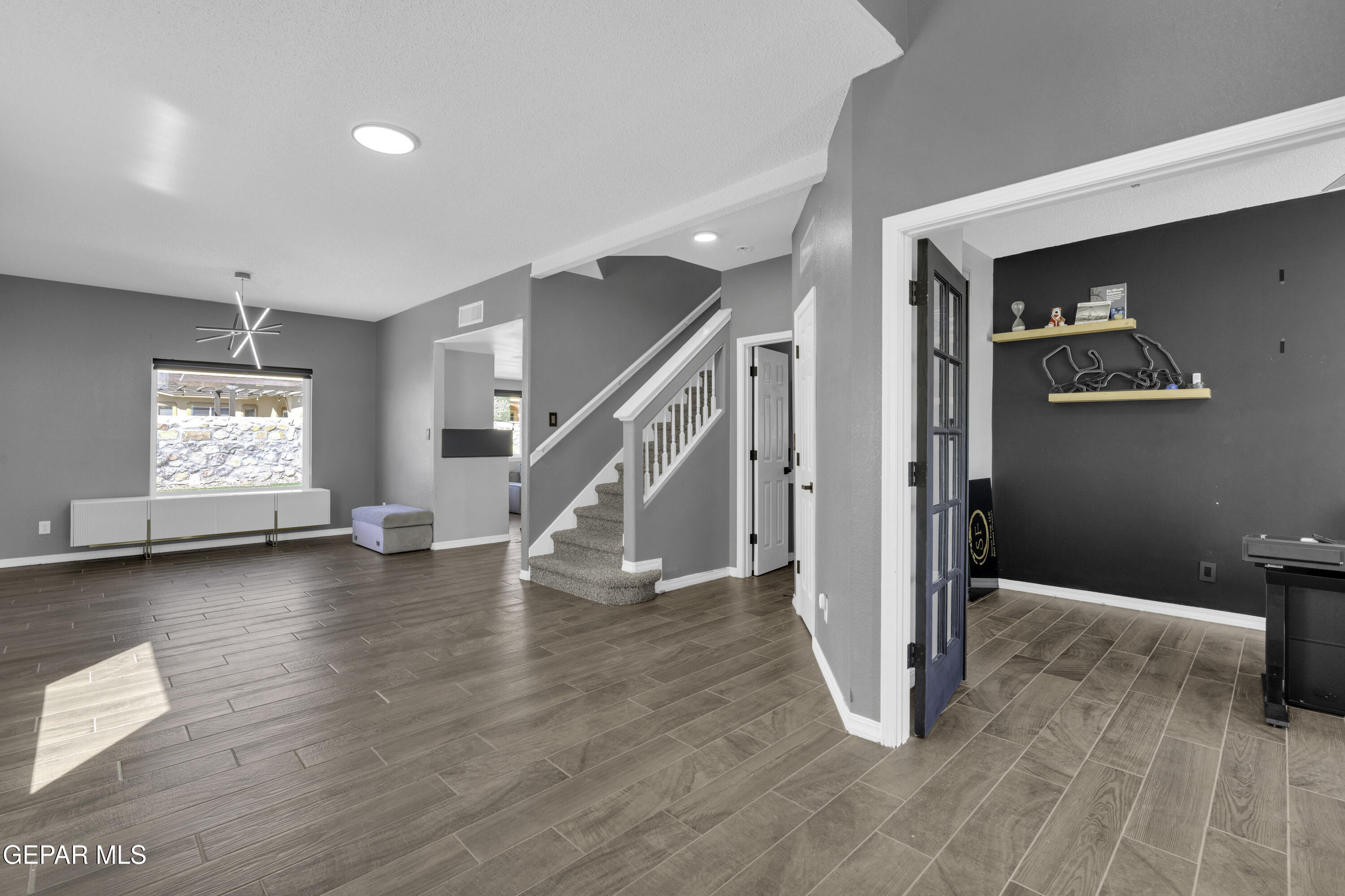 6341 Cougar Ridge Lane El Paso, TX 79912 - Photo 6 of 71 a view of empty room with wooden floor and fan