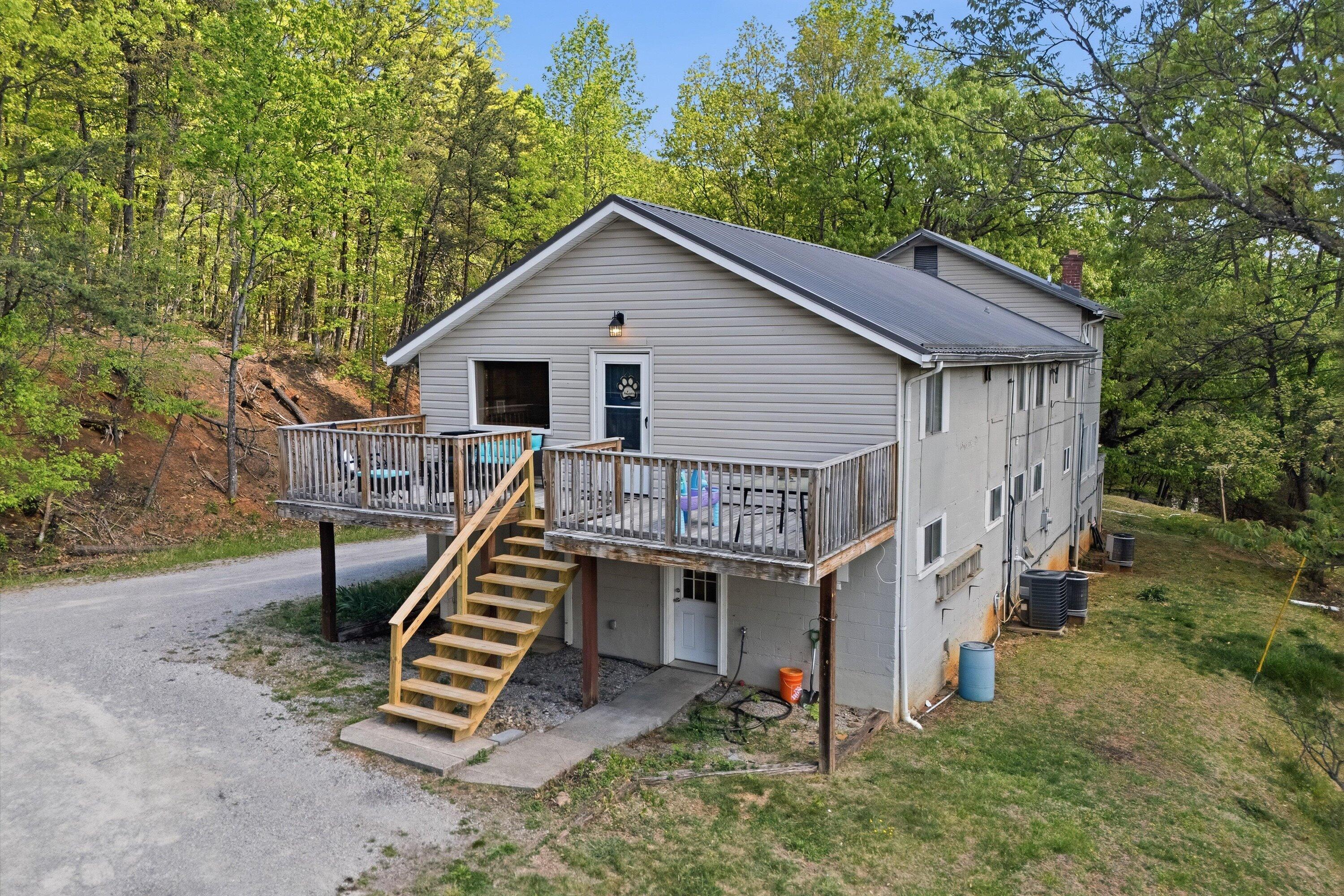 a view of a house with a yard and furniture