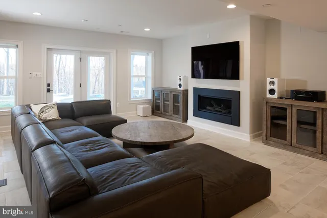 a living room with furniture a fireplace and a flat screen tv