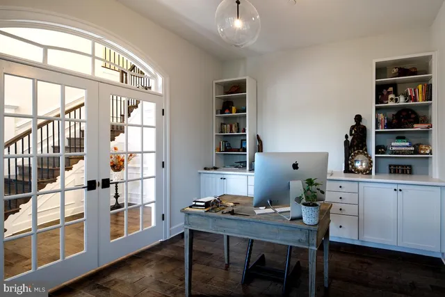 a workspace with furniture window and wooden floor