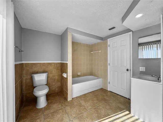 a bathroom with a toilet sink and shower