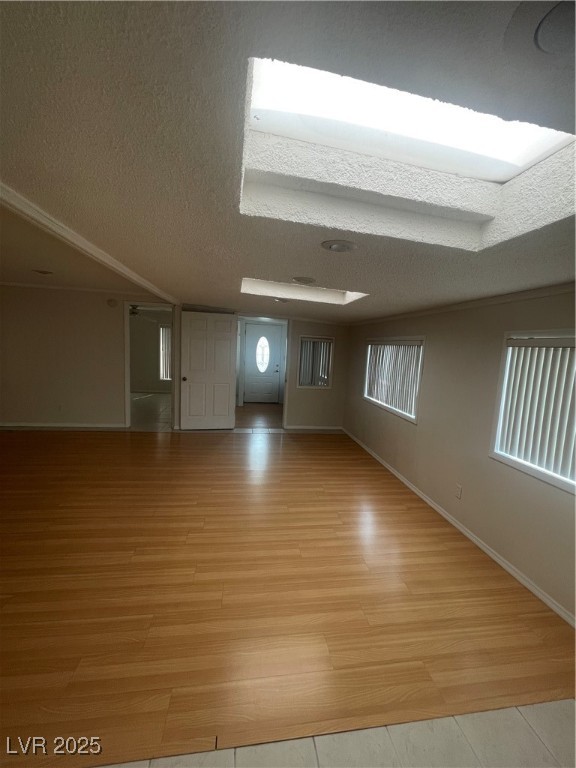 4641 Royal Ridge Boulevard Las Vegas, NV 89103 - Photo 13 of 38 Unfurnished room with a textured ceiling and light wood-style floors