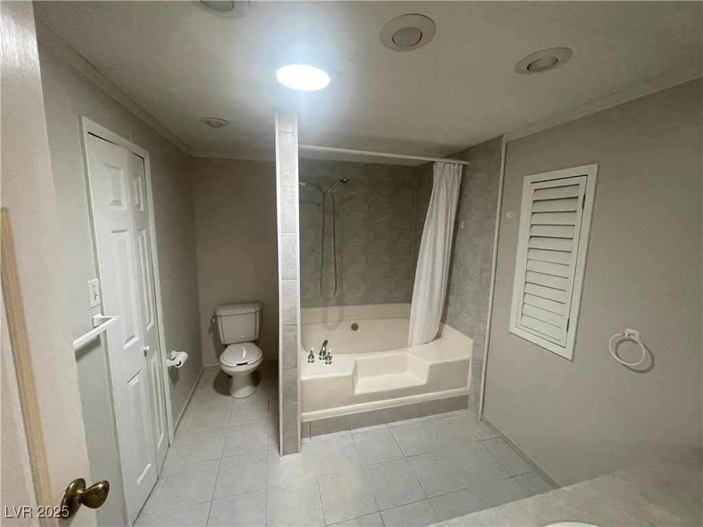 4641 Royal Ridge Boulevard Las Vegas, NV 89103 - Photo 19 of 38 Bathroom with shower / bathtub combination with curtain, tile patterned flooring, and ornamental molding