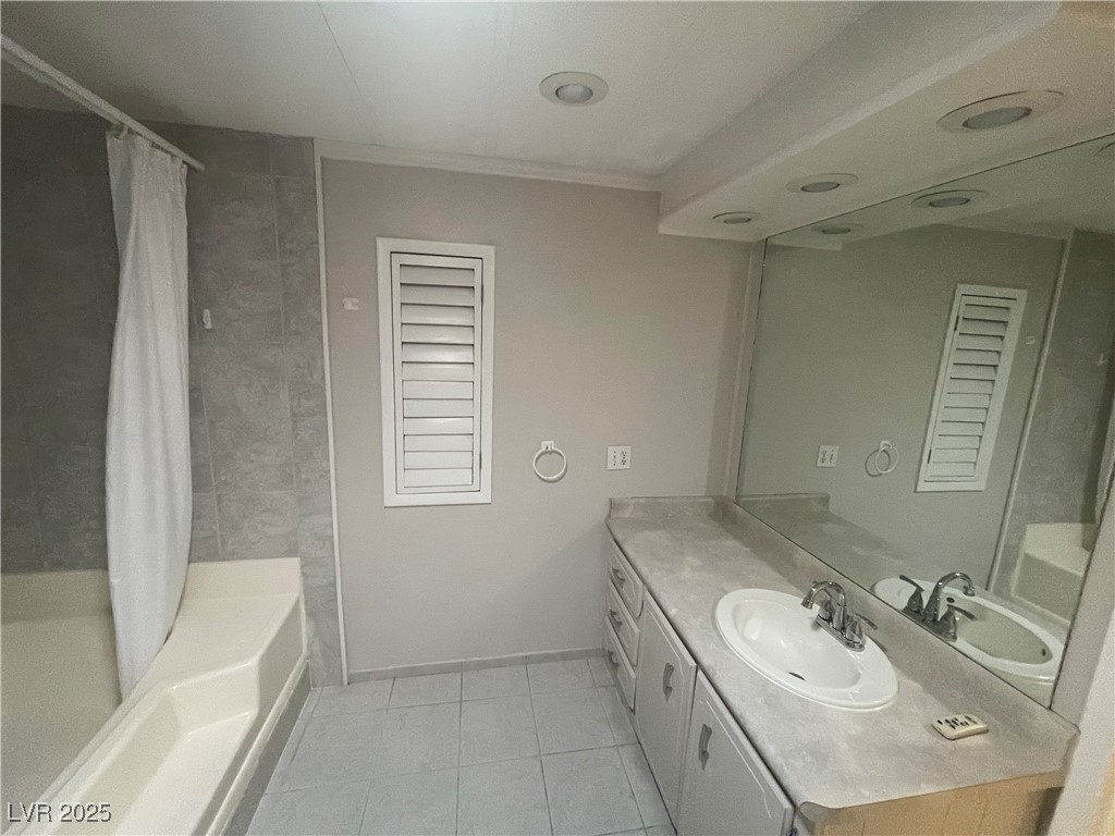 4641 Royal Ridge Boulevard Las Vegas, NV 89103 - Photo 20 of 38 Full bathroom featuring vanity, shower / bathtub combination with curtain, and tile patterned flooring
