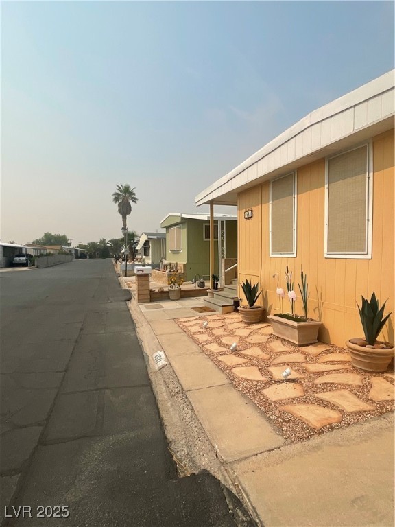 4641 Royal Ridge Boulevard Las Vegas, NV 89103 - Photo 2 of 38 View of side of home featuring a residential view
