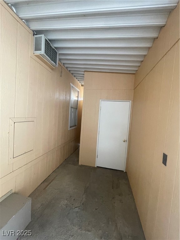 4641 Royal Ridge Boulevard Las Vegas, NV 89103 - Photo 22 of 38 Hall with unfinished concrete flooring and a wall unit AC